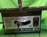 Photo of Skilsaw front panel with blade angle control, power switch, and branding.