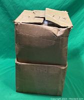 Two closed cardboard boxes stacked, containing wire clips.