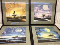 Overall view of the four framed watercolor Asian seasonal paintings showing river scenes with boats and the changing seasons.