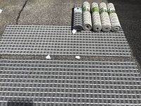 View of all seven floor runners laid out and rolled, showing patterns and backing.