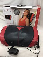 Photo of the Casada Maxiwell III massager with packaging showing the product name, usage image, and logo.