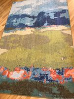 Full view of the larger 5 ft x 8 ft Casablanca rug showing its multicolor abstract pattern including blue, green, and orange hues.