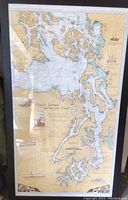 Full view of framed map leaning against wall