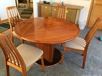 Full view of round table and four chairs showing overall set and finish