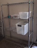 Front and side view of 4-tier chrome metal wire shelving unit with various clear plastic storage bins on the shelves