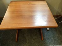 Top-down view showing wood grain and wear on the tabletop surface.