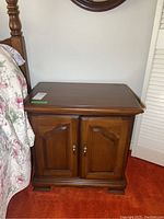 Wood nightstand from side view showing rectangular shape and finish.
