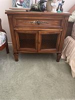 Full front view of the nightstand showing drawer and two doors with mesh inserts