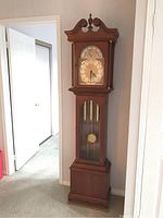 Front view showing entire clock from base to pediment