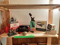 Shelf with chemo splicer unit on box, zoom slide duplicator, head magnifying glass in box, focus scope in box, and Panaroma II slide viewer boxed.
