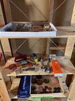 Shelf with Mastercraft screwdriver set, measuring tapes, clamps, staples, furniture protectors, and vintage pins on bottom shelf