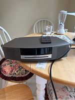 Front view of Bose Wave Music System on table with remote on top