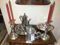 Photo showing entire set with candle holders, teapot, cream and sugar, tray, spoons, and oval dish with handle