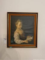 Full view of framed print showing girl reading a book, framed without glass, with a gold-toned decorative frame measuring about 18x14 inches.