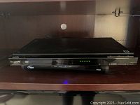 Sony DVP-SR500H DVD player front view showing Sony branding, power and function indicators, and disc tray
