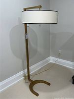 Full-length view showing U-shaped base, vertical post, horizontal arm and shade