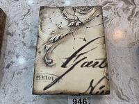 Front view of Sid Dickens 'Quill' tile showing embossed swirl design and script text on cream-colored surface.