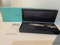 Two-piece set in black velvet-lined Tiffany & Co presentation box with outer light blue Tiffany box visible beyond.