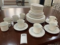 Overall view of stacked plates with cups and saucers on table
