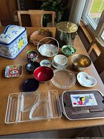 Full lot view showing all items including bowls, ashtrays, decorative boxes, trays, and other serveware on a wooden table.