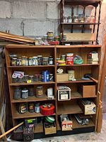 Wooden shelving units filled with various jars and boxes containing small hardware items