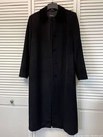 Front view of the vintage Brooks Brothers black long coat displaying the velvet collar, covered button placket, sleeve length, and overall length.