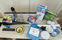 Photo showing all items included in the lot: cleaning products, tools, and accessories arranged on a flat surface.