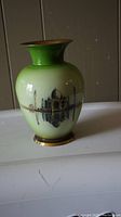 Glossy green brass vase with painted Taj Mahal and reflection on one side