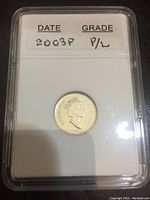 Close-up photo of the 2003P Canadian dime in a plastic graded holder showing the obverse with Queen Elizabeth II and grading information.