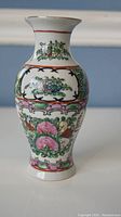 Front view of porcelain vase with intricate colored floral design.