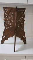 Side view of the 21" high wooden bracket showing the carved leaf and foliage detail and overall shape.