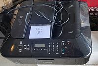 Top view of Canon MX432 printer showing keypad, display, and cables on top.