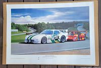 Front view of full poster showing two race cars on the track, vibrant colors, signed and dated at bottom.