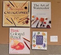 Top-down view of four art instruction books arranged on a cardboard background; includes titles and cover art identifying the books in good condition.