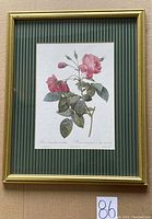 Framed vintage print of pink roses by Hart Lake with gold frame and green striped matting.