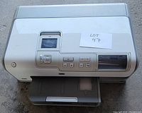 Top view of the HP Photosmart D7160 showing control panel, color LCD screen, paper tray extended.