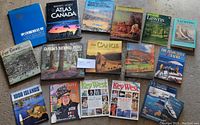 Full overview of all 17 books showing spines and front covers including subjects of Canada, yachting, outdoor lifestyle, national parks, and travel guides.
