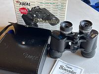 Focal binoculars, leather carrying case, instruction manual, and original box arranged for inspection.