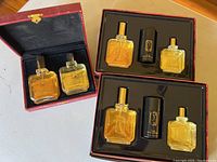 View of two boxed PS brand sets containing cologne and after shave bottles with one deodorant stick each.