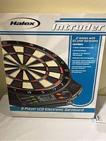 Front view of the boxed Halex Intruder Electronic Dartboard showing the dartboard, brand name, and highlighted features.
