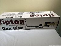 Full view of the Tipton gun vise retail packaging, showing branding and product illustration.