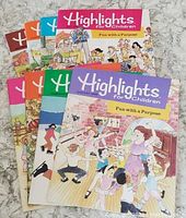 Photo showing full set of nine Highlights for Children magazines from 1989 arranged fanned out on a flat surface.