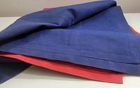 Close-up image showing folded dark blue canvas fabric with stitched edges as part of the inflatable mattress.