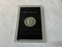 Obverse side of the 1971 Eisenhower proof dollar coin in protective plastic case, showing the front profile and inscriptions.