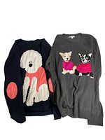 Navy blue sweater with a large white poodle design wearing a pink sweater, showing elbow patches.