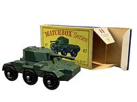 Side view of the Saladin Armoured Car diecast model with original box in background
