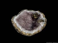 Front view of amethyst geode showing purple and white crystalline interior surrounded by brown rough exterior rock.