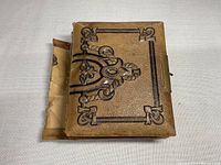 Photo of the detached leather-bound book cover showing decorative embossing.