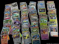 Multiple columns of sleeved holographic Pokémon cards laid out on a table