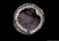 Top view of the amethyst geode showing the purple crystals and white border.